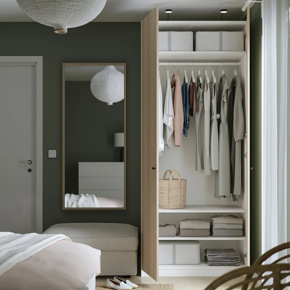Neat bedroom with open closet. Hangs clothes, stores folded clothes, and utilises shelves.
