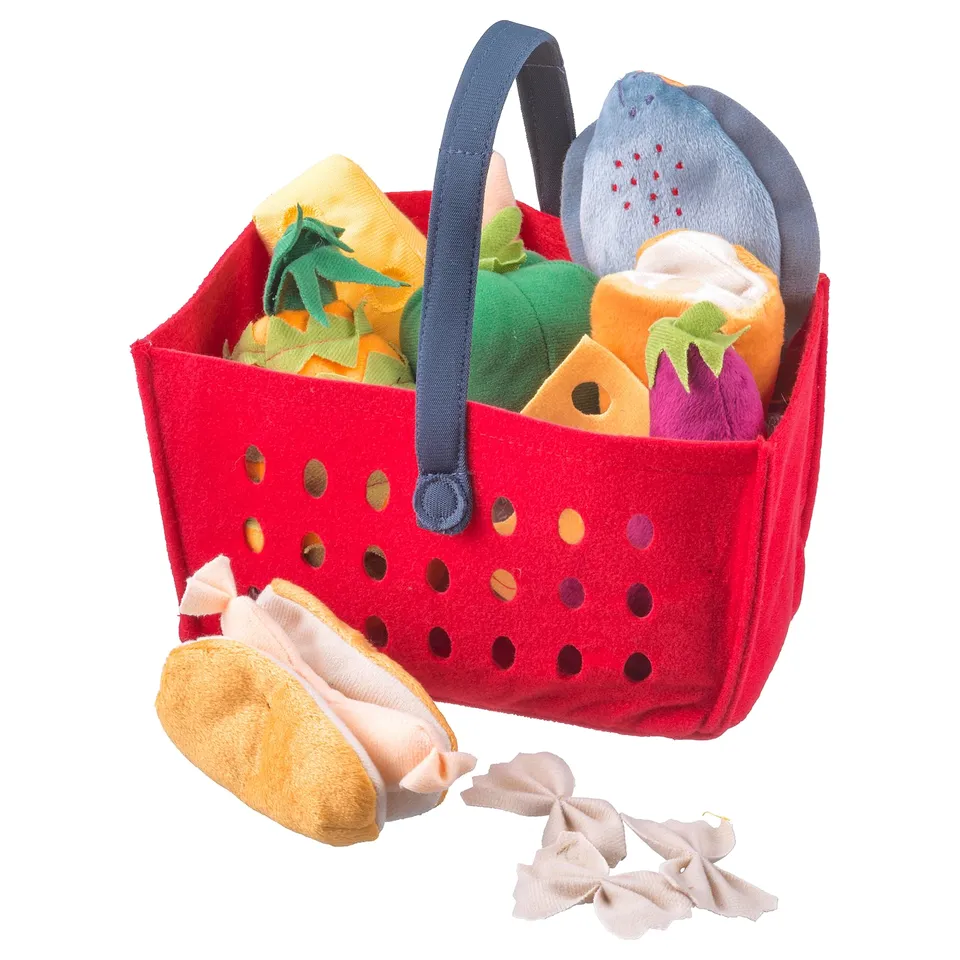 Red felt toy shopping basket with blue handle, filled with colourful plush food items.