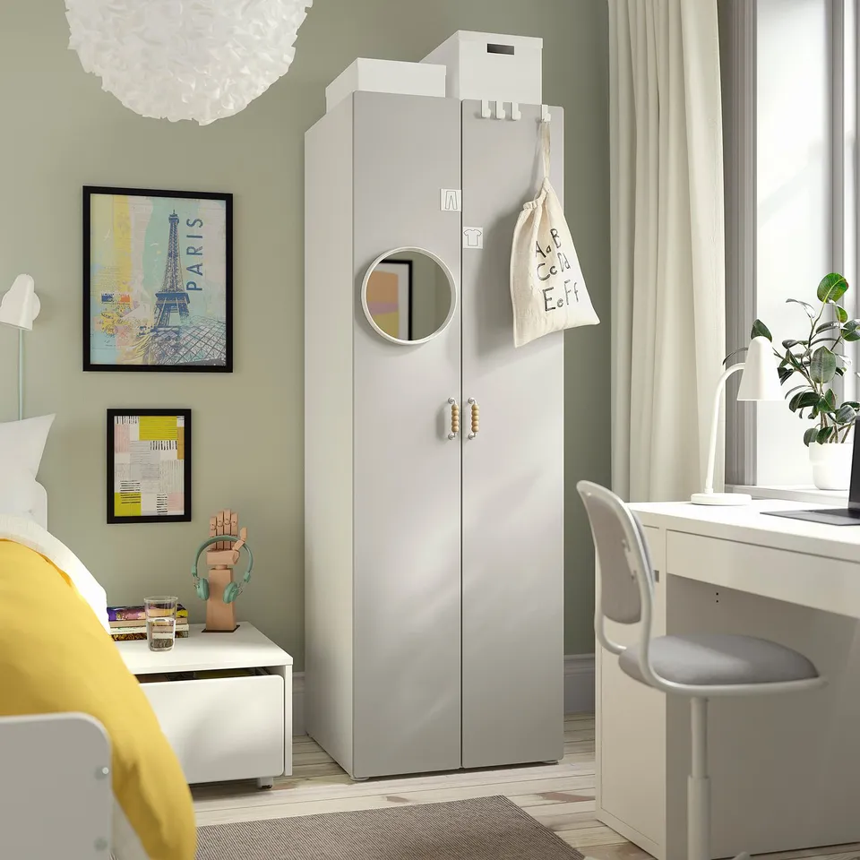 Modern kids room with grey SMÅSTAD wardrobe, mirror, desk, and paris-themed art.