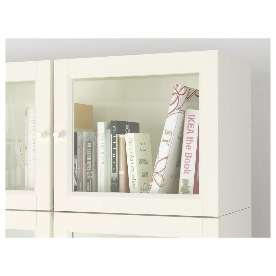 Bookshelf with glass doors showcasing books; adjustable shelves.