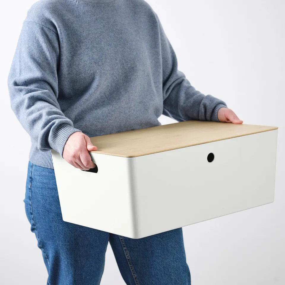 Person carrying a large storage box. Handles ensure easy lifting and carrying.