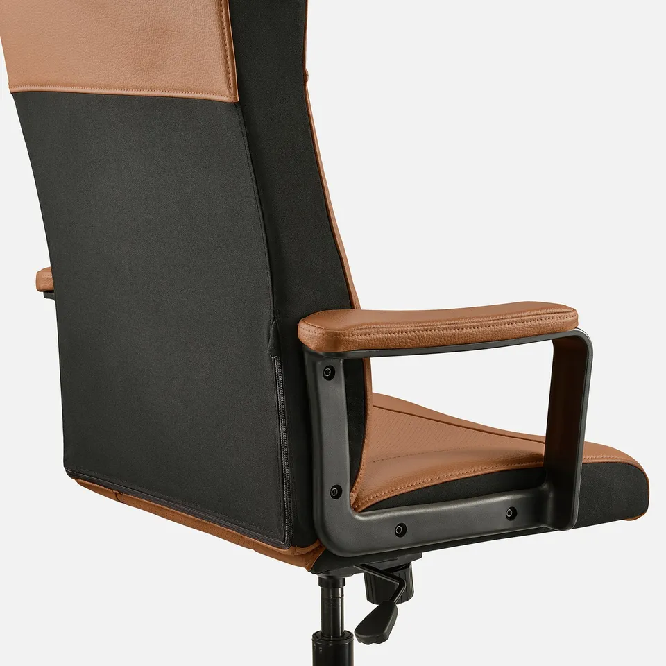 Ergonomic office chair with adjustable armrests, featuring breathable mesh and plush tan fabric, sturdy black base for stability.