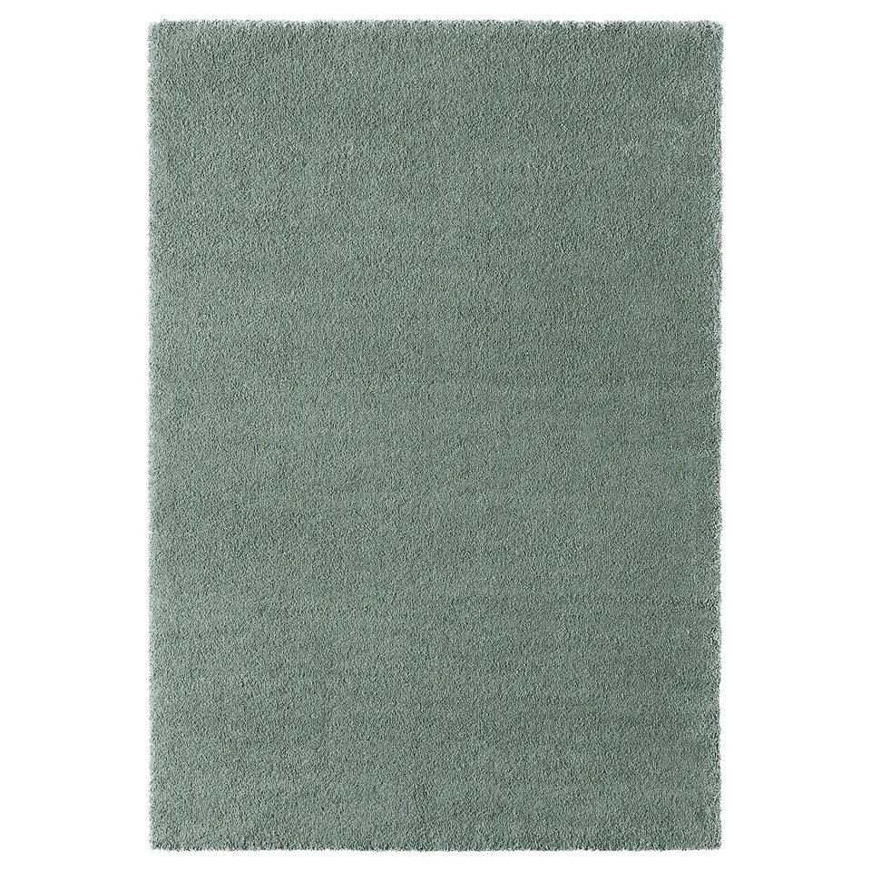 A STOENSE rug, rectangular, light green, soft material, low pile design.