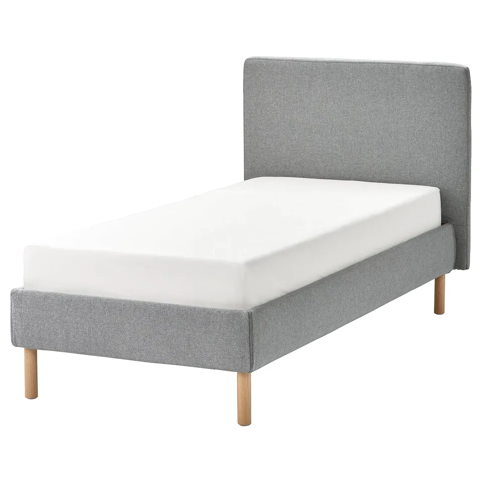 TÄRNKULLEN bed in grey fabric with wooden legs and a white mattress.