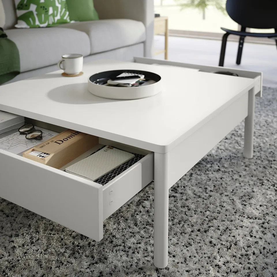 Off-white TONSTAD coffee table, sleek design, rectangular storage drawers, minimalist home decor.
