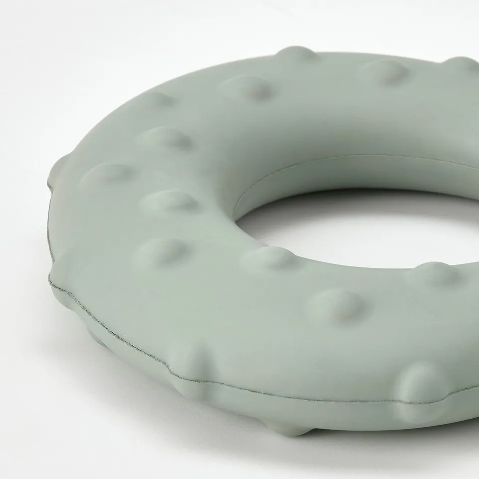 Circle-shaped dog toy with bumpy texture, designed for durability and fun.