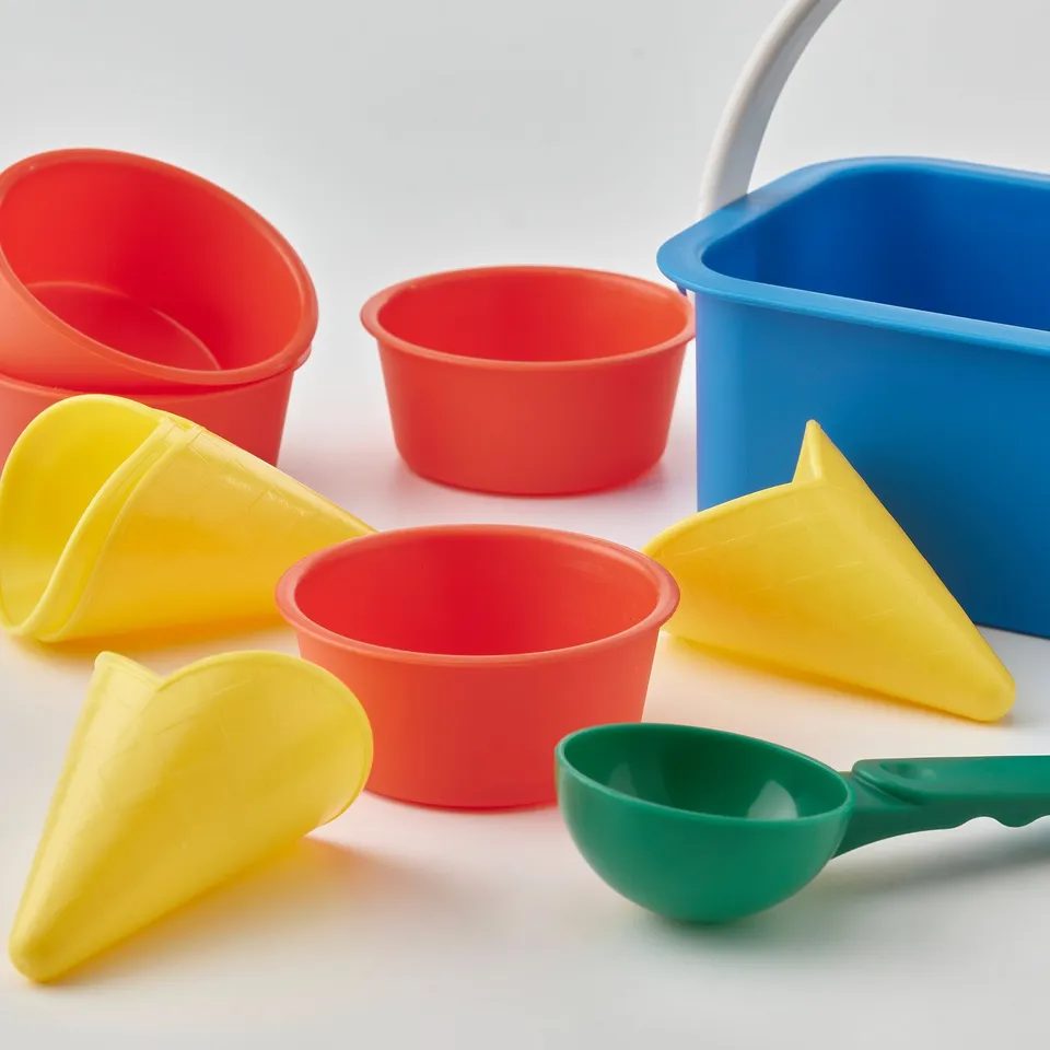 Bright, colourful plastic ice cream play set with cones, cups, and scooper; durable, safe for kids.