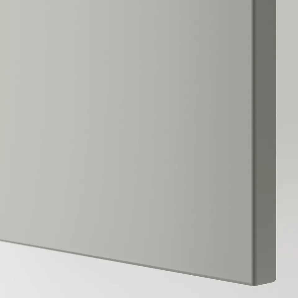 Close-up of sleek, modern kitchen cabinet edge with smooth, light grey finish.