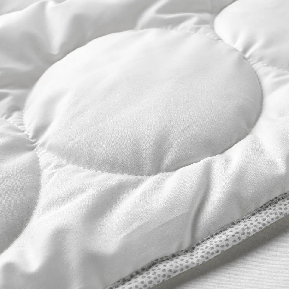 Soft, textured baby duvet with rounded edges, made of smooth, high-quality fabric.