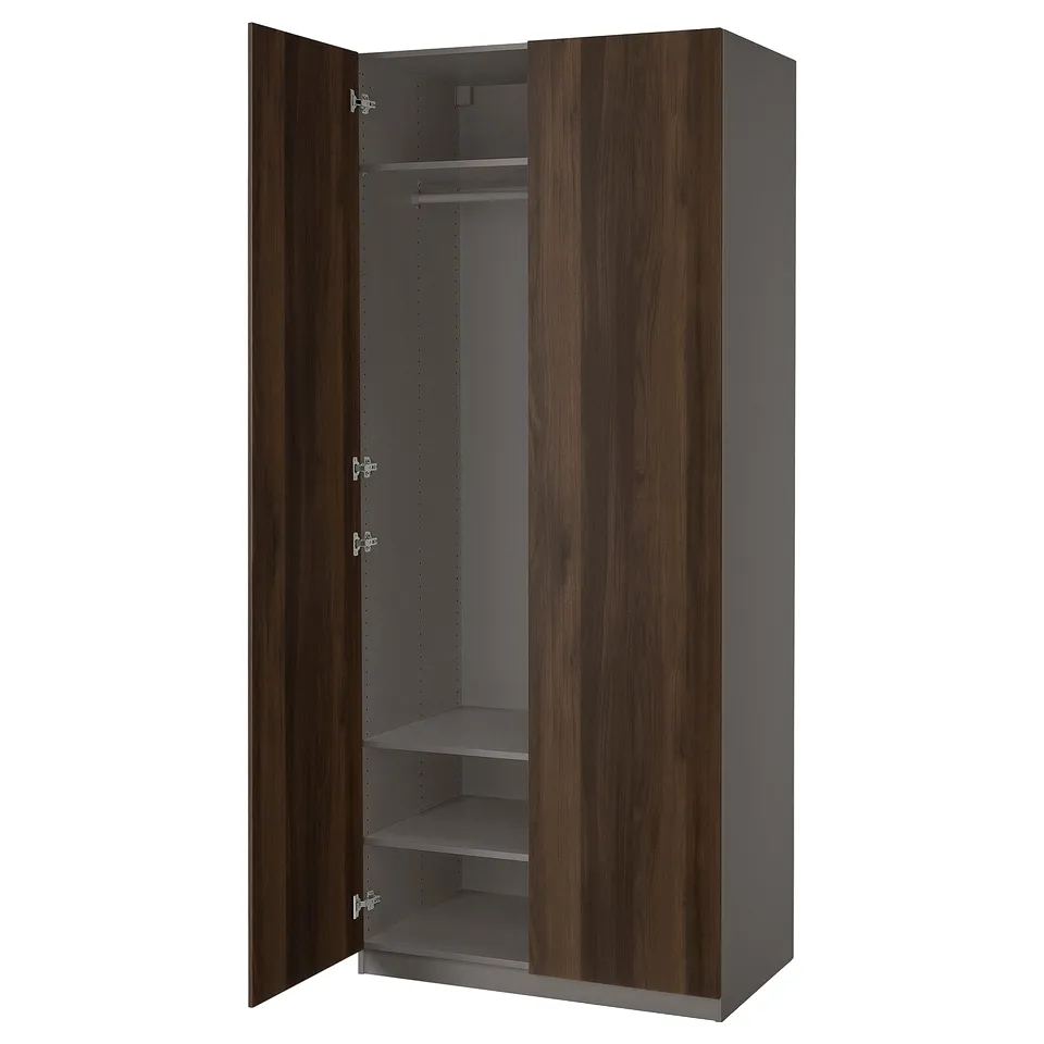 An open ikea PAX wardrobe in dark brown with wooden doors. It has shelves and a hanging rod inside.