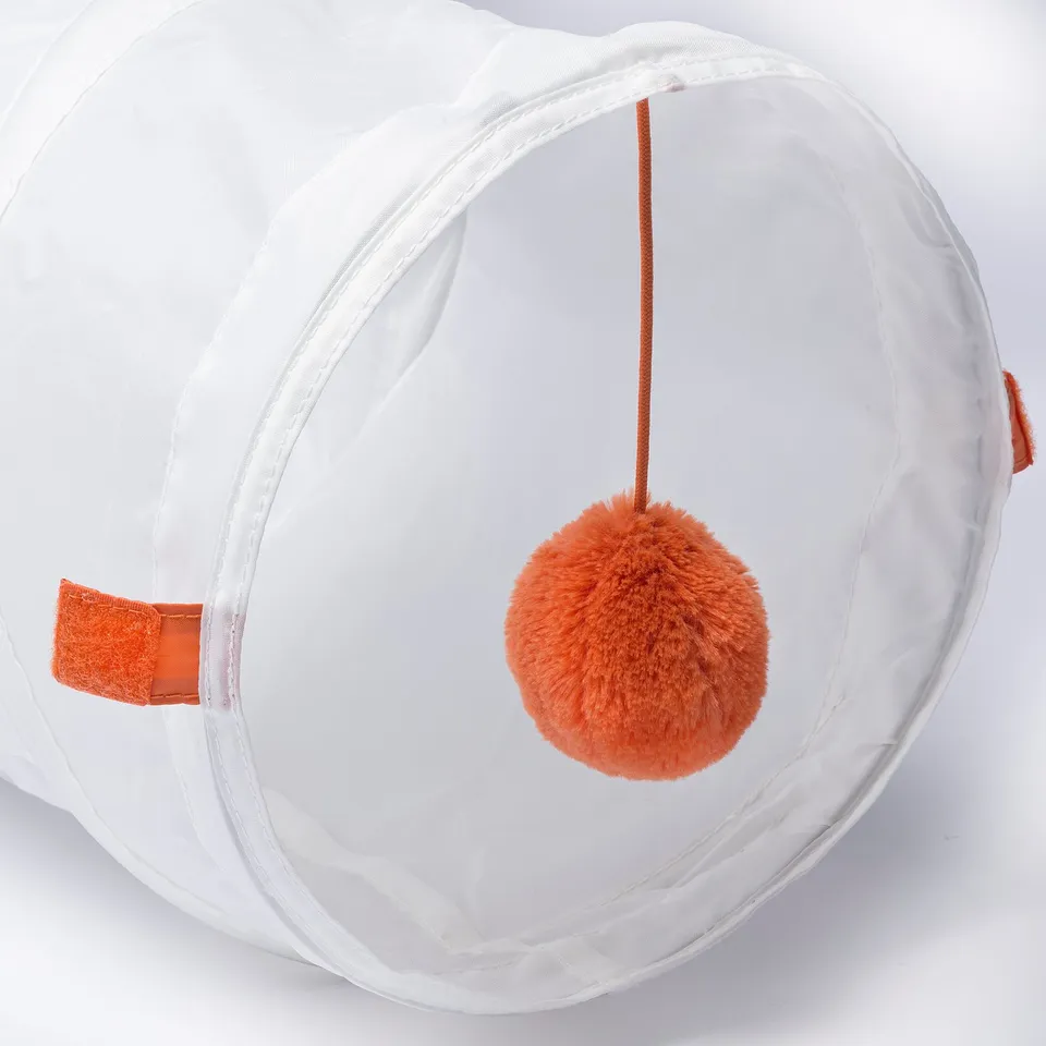 White cat play tunnel with orange pom-pom toy inside, high-quality fabric, and sturdy structure.