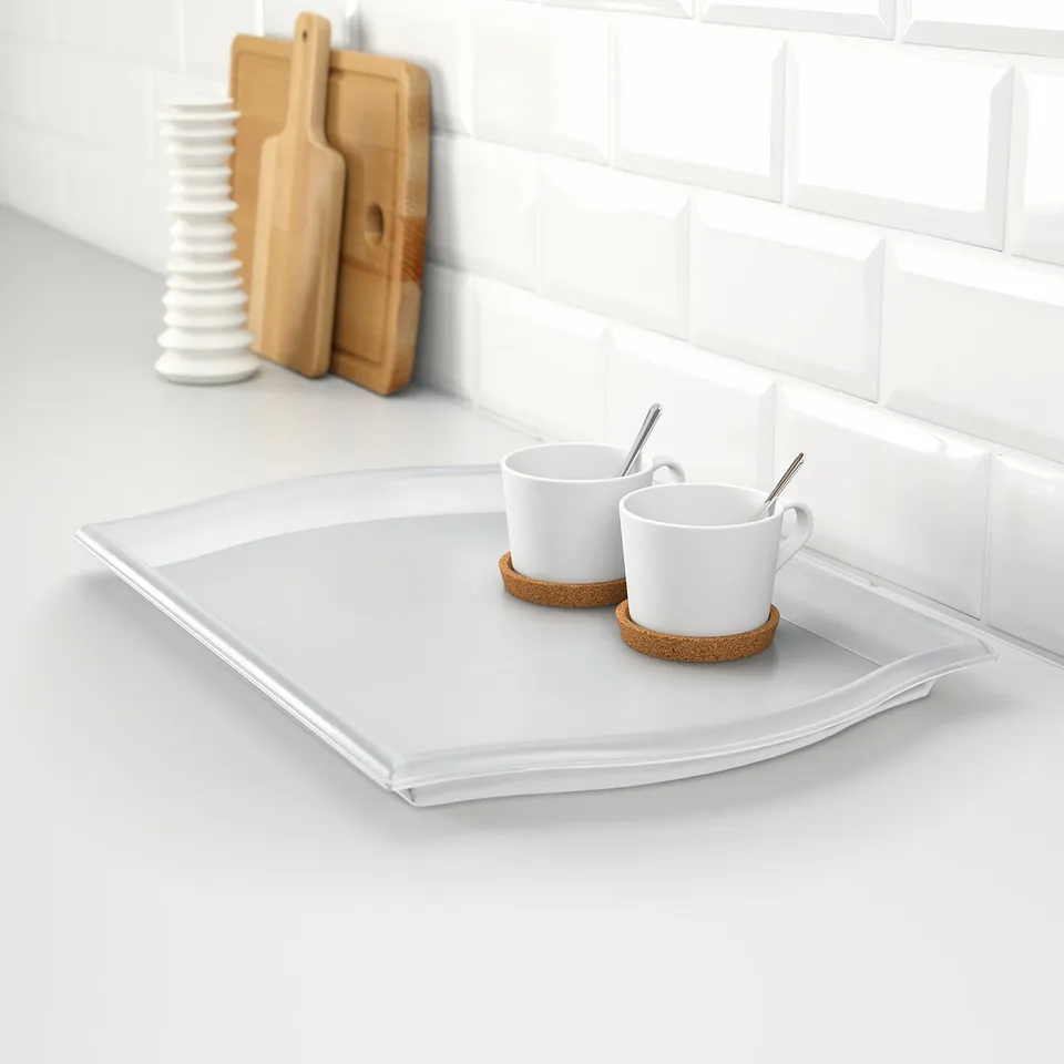 White serving tray with handles, holding two coffee cups and saucers. Ideal for carrying items to save trips.