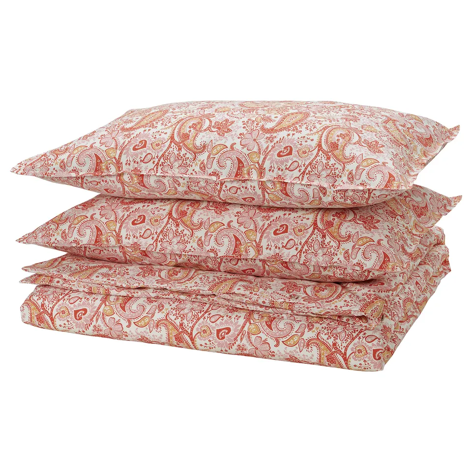 Stack of four red-white paisley pattern bed linens; rectangular, soft, cotton-blend.