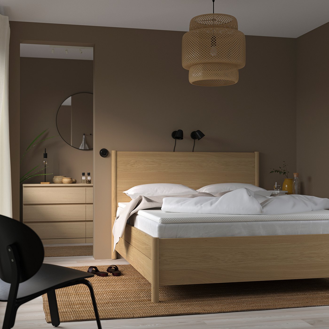 Minimalist bedroom: wooden bed, white linens, dark walls, hanging lamp, matching dresser and chair.