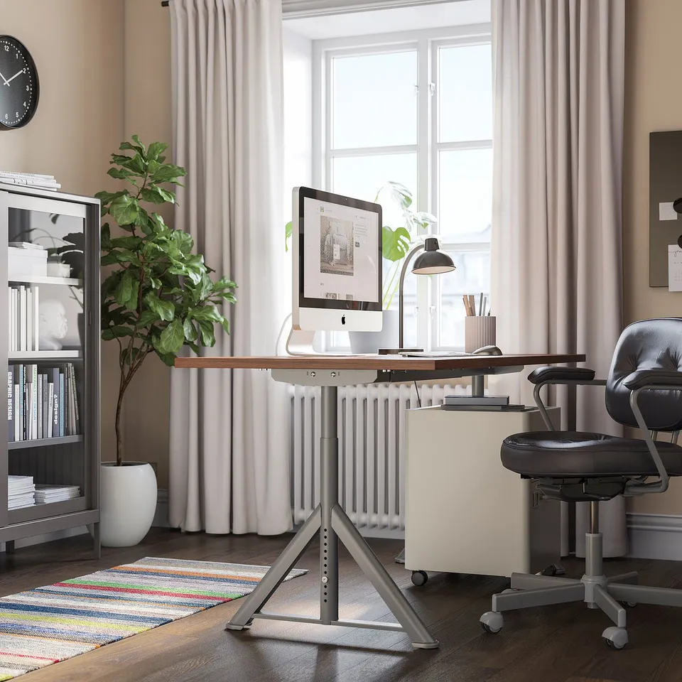 Home office with IDÅSEN desk, chair, and large window with curtains and rug.