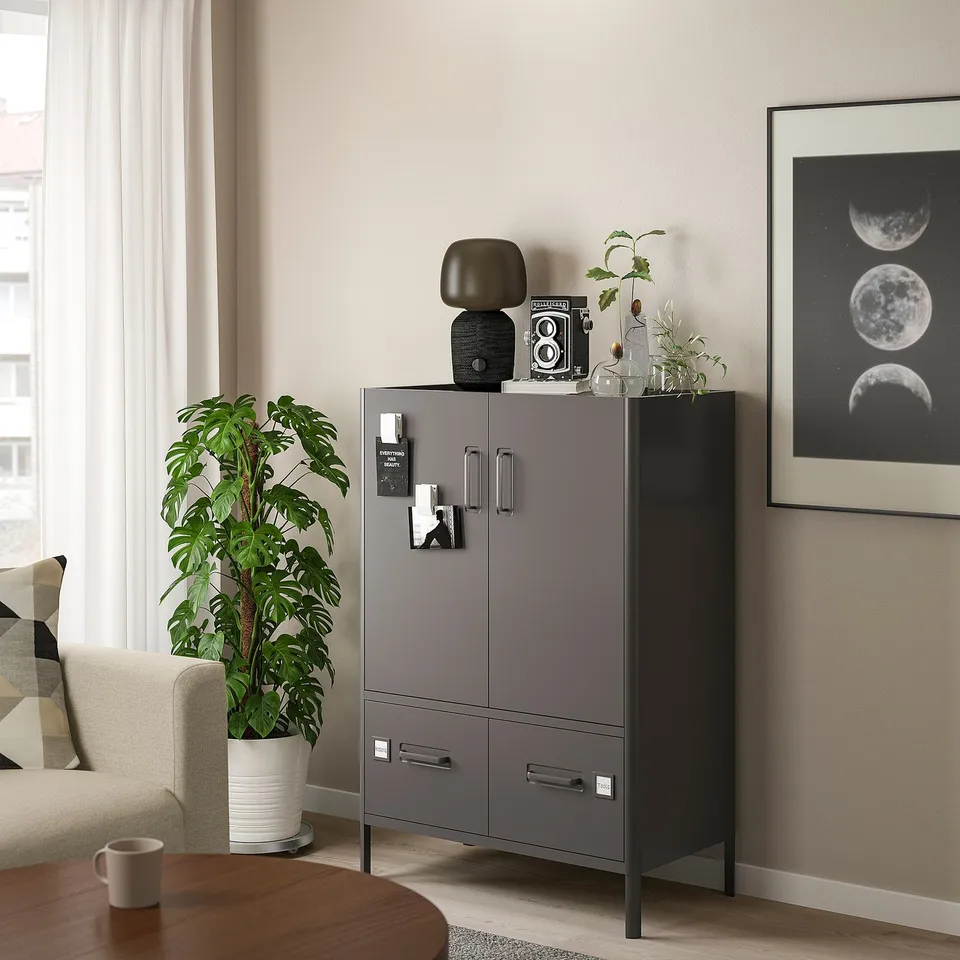 Modern living room with IDÅSEN grey cabinet, white plant, and moon wall art.