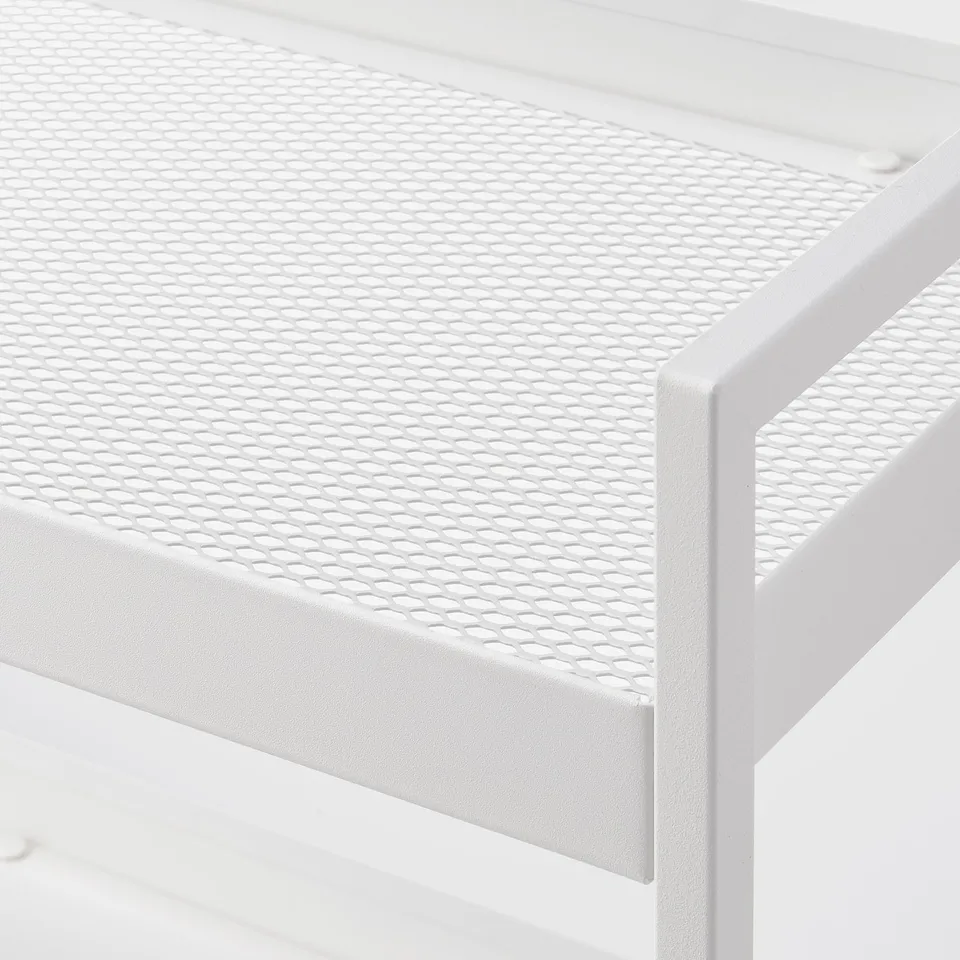Close-up of white metal storage shelf, showcasing sturdy, powder-coated mesh surface and robust frame.