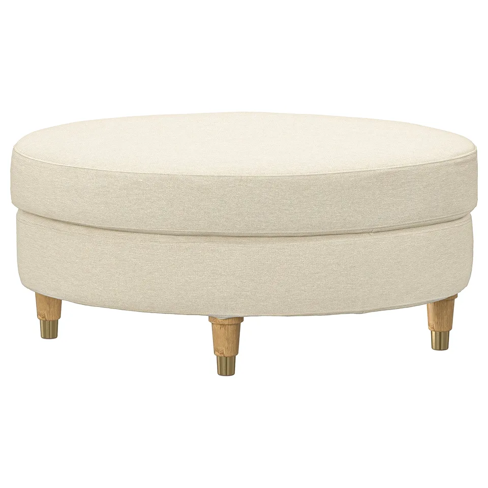 VALNÄS cream round footstool with brass legs.