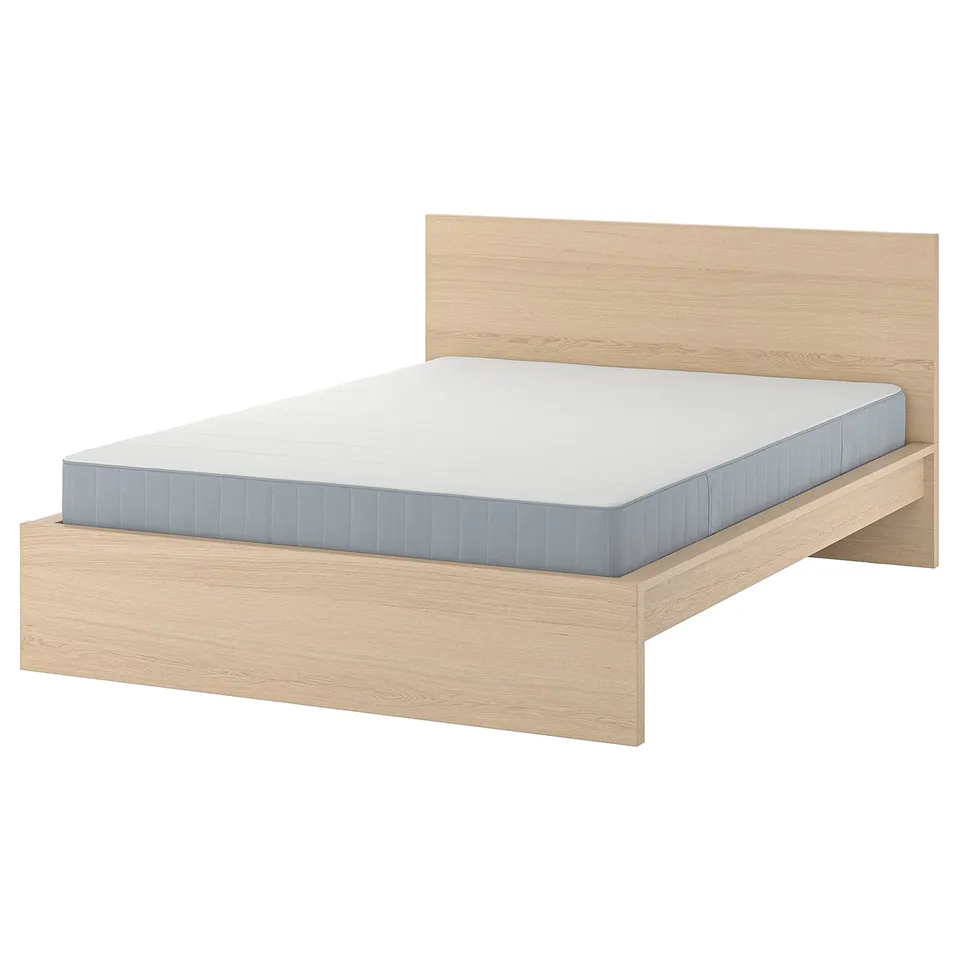 Modern wooden bed with white mattress. Clean, minimalist design. Light oak finish.