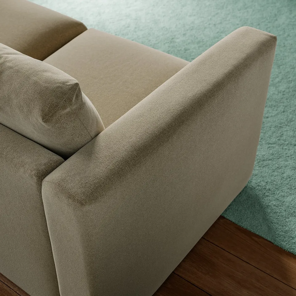 A beige sofa corner with soft, inviting fabric and supportive cushions on a turquoise carpet.
