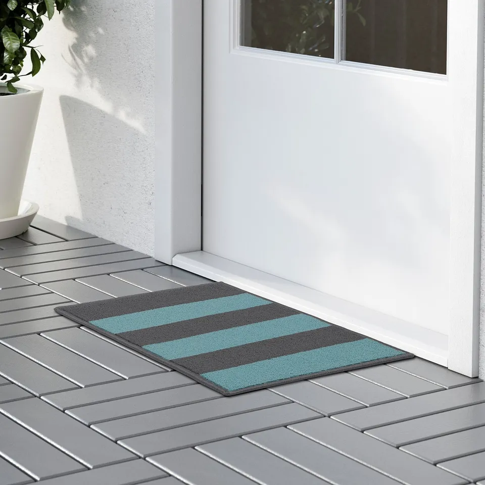 Door mat with teal and grey stripes. Machine-tufted and has non-slip backing for safety and easy cleaning.