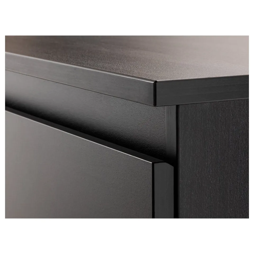 Dark wood chest with sleek, modern edges. Drawers are smooth and show high-quality craftsmanship.