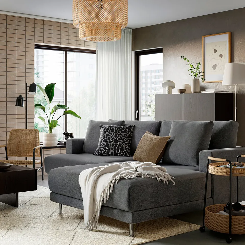 Modern living room with large grey UPPÅKRA sectional sofa, buchanan patterned cushions, cosy throw, and natural decor; stylish and inviting.