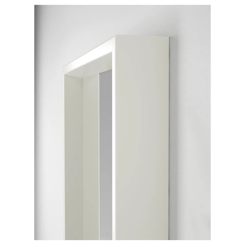 Modern, sleek white tri-fold mirror, ideal for bathrooms and dressing rooms, hangs securely on the wall.