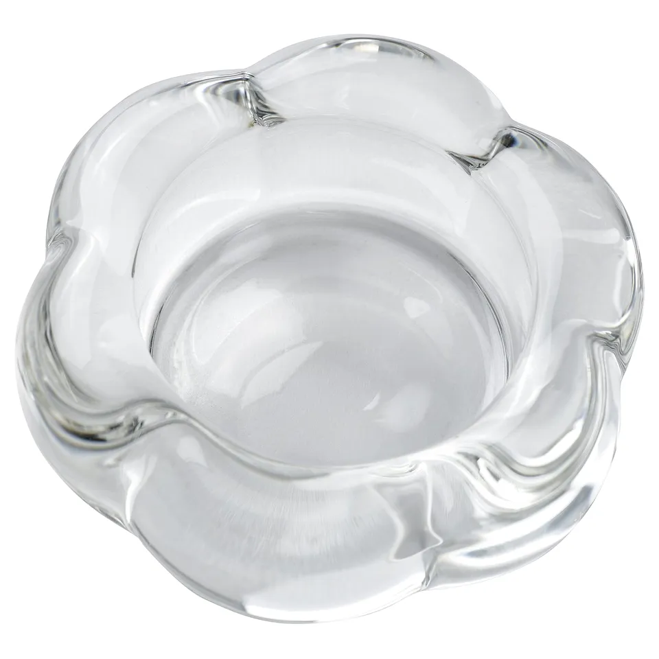 Clear glass tealight holder, flower-shaped, modern design.