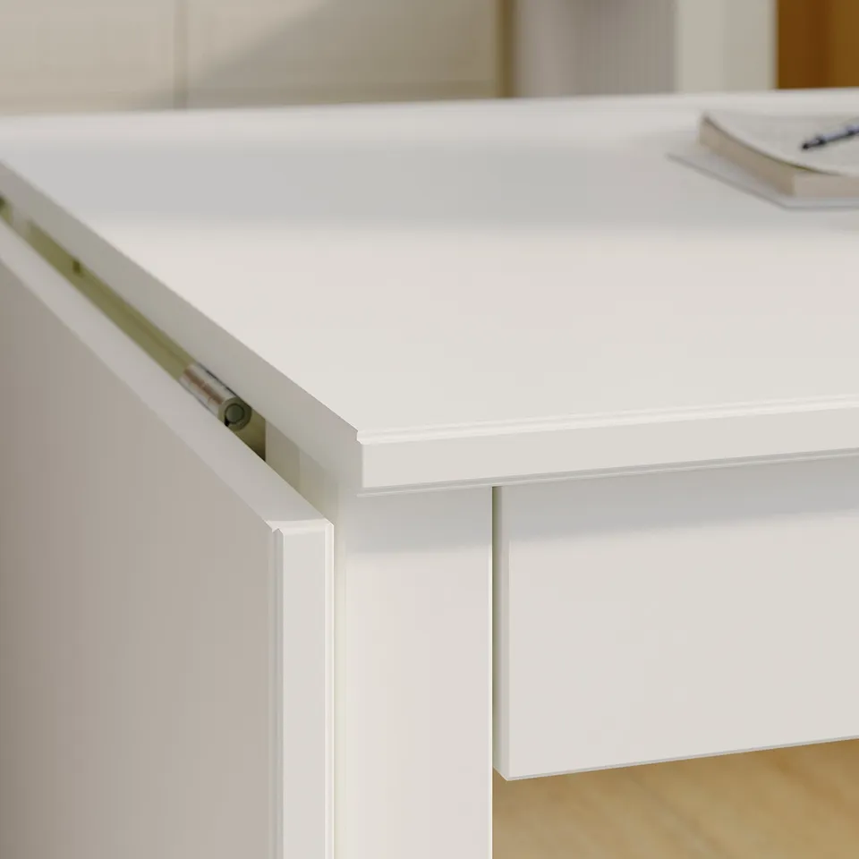 Close-up view of a neat white table with clean edges and smooth finish. A pen and pad rest on top.