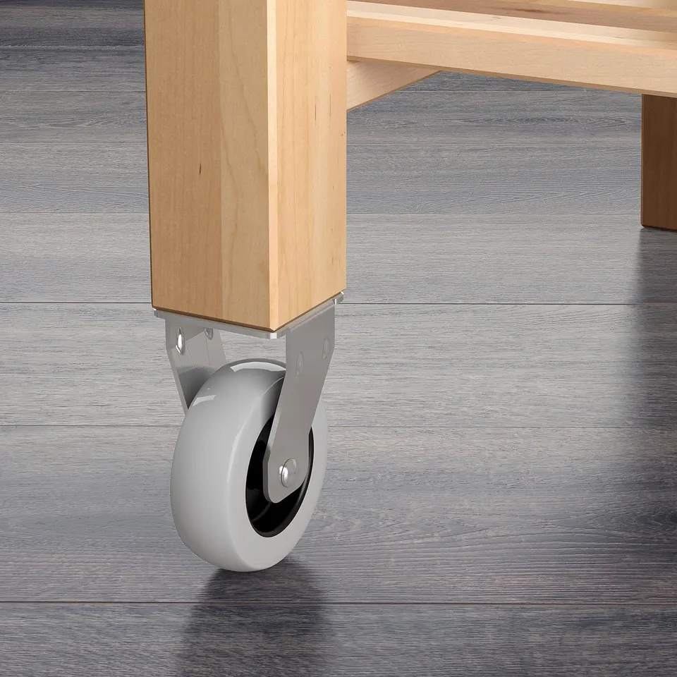 A wooden trolley with a smooth, light birch finish and sturdy, wheels for easy mobility.