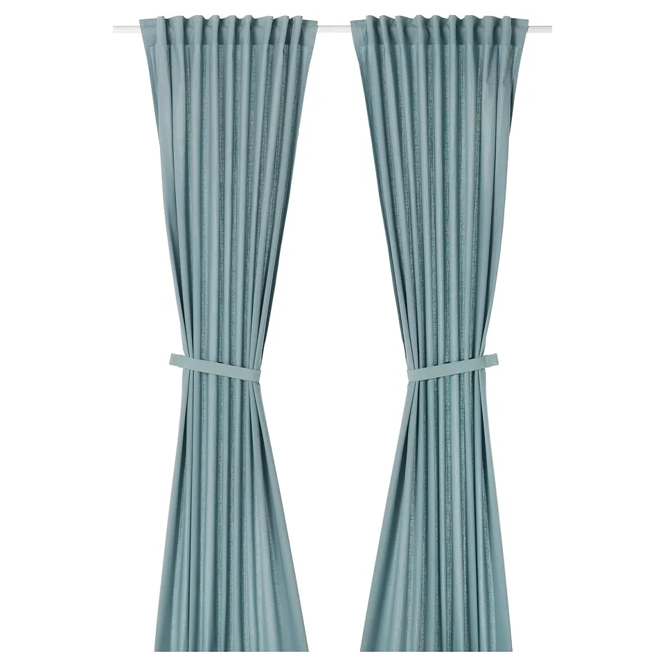 Two light grey-blue RITVA curtains, made of cotton, hanging straight with tie-backs.