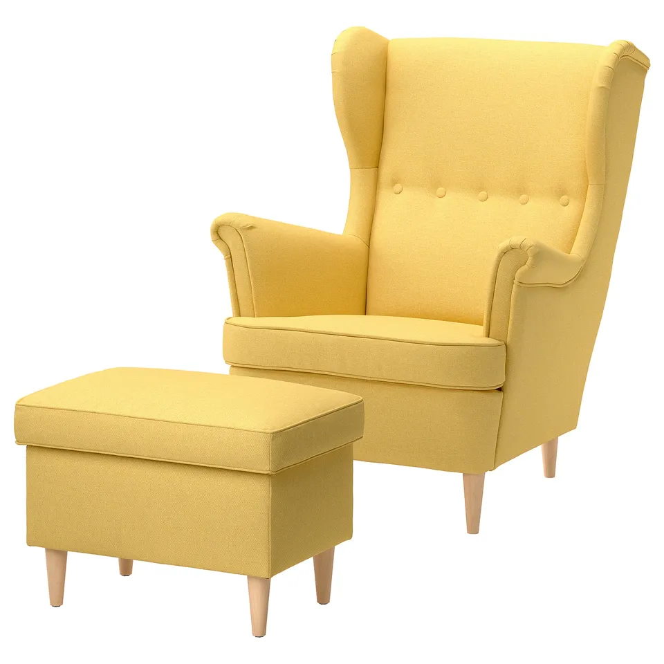 Bright yellow STRANDMON wing chair and ottoman, modern design with soft, cushioned seating and wooden legs, perfect for relaxing.