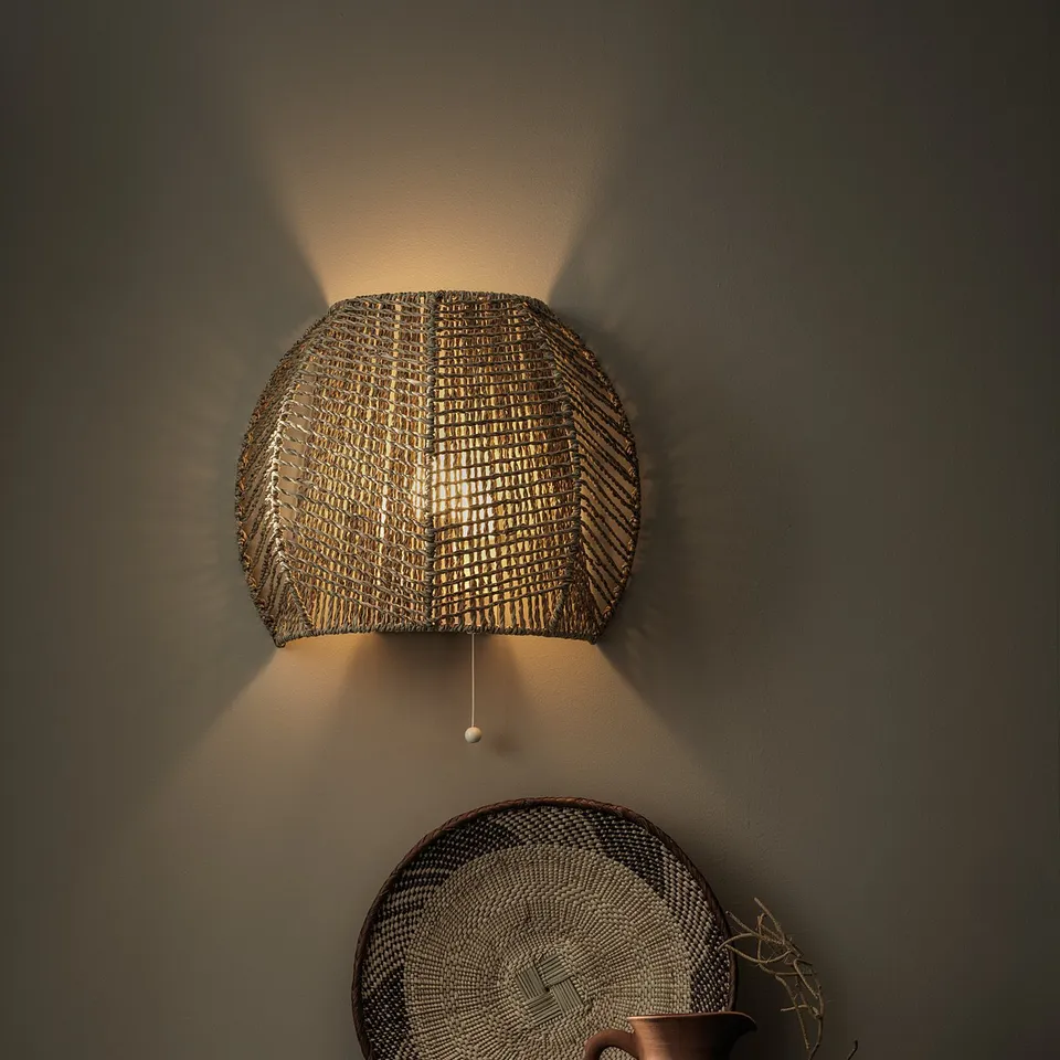 Hand-braided wall lamp, natural sedge, warm multi-directional light, rustic earthy tones, cosy atmosphere.