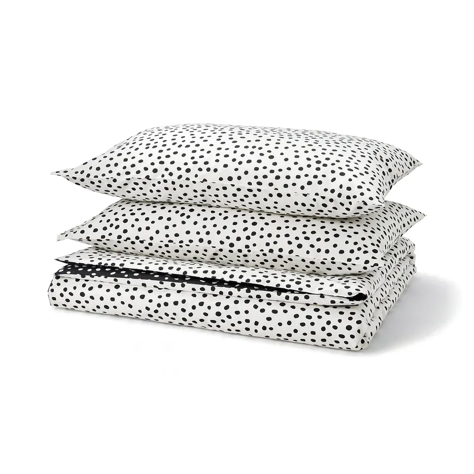A BJÖRKGRÅMAL duvet cover set in white with black dots, made from 54% cotton and 46% viscose. It a soft, patterned design with a zip closure.