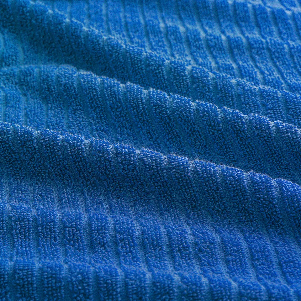 Blue textured towel, soft and absorbent, woven stripes and terry design.