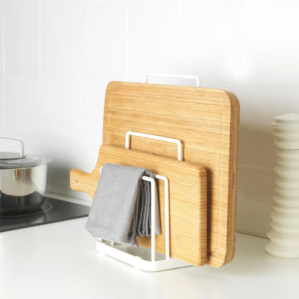 Kitchen counter with cutting boards and towels.