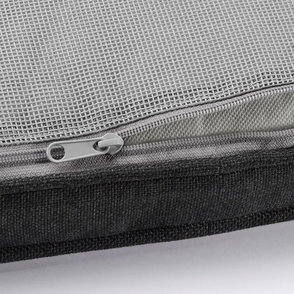 Mesh fabric zip close-up, light grey and black tones, durable outdoor cushion material.