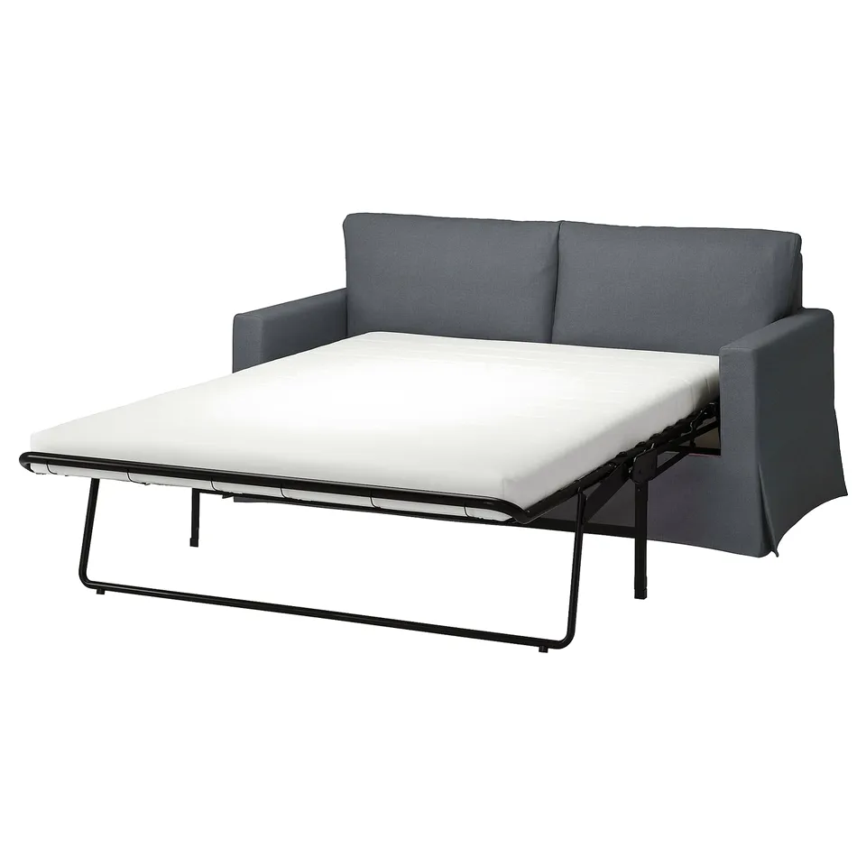 A dark grey HYLTARP sofa bed in a modern design with a white mattress, ideal for small spaces.