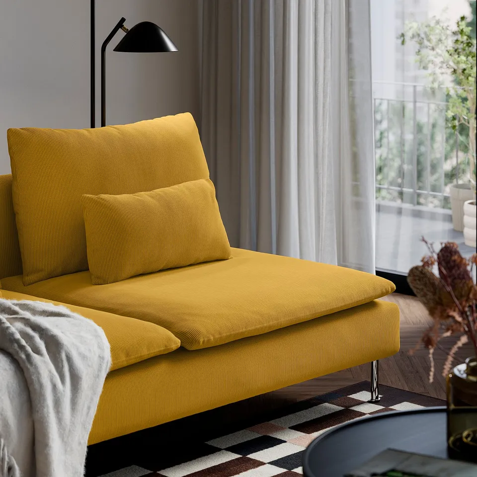 Yellow SÖDERHAMN sofa with deep seats and loose cushions. Large windows with sheer curtains and a black floor lamp.
