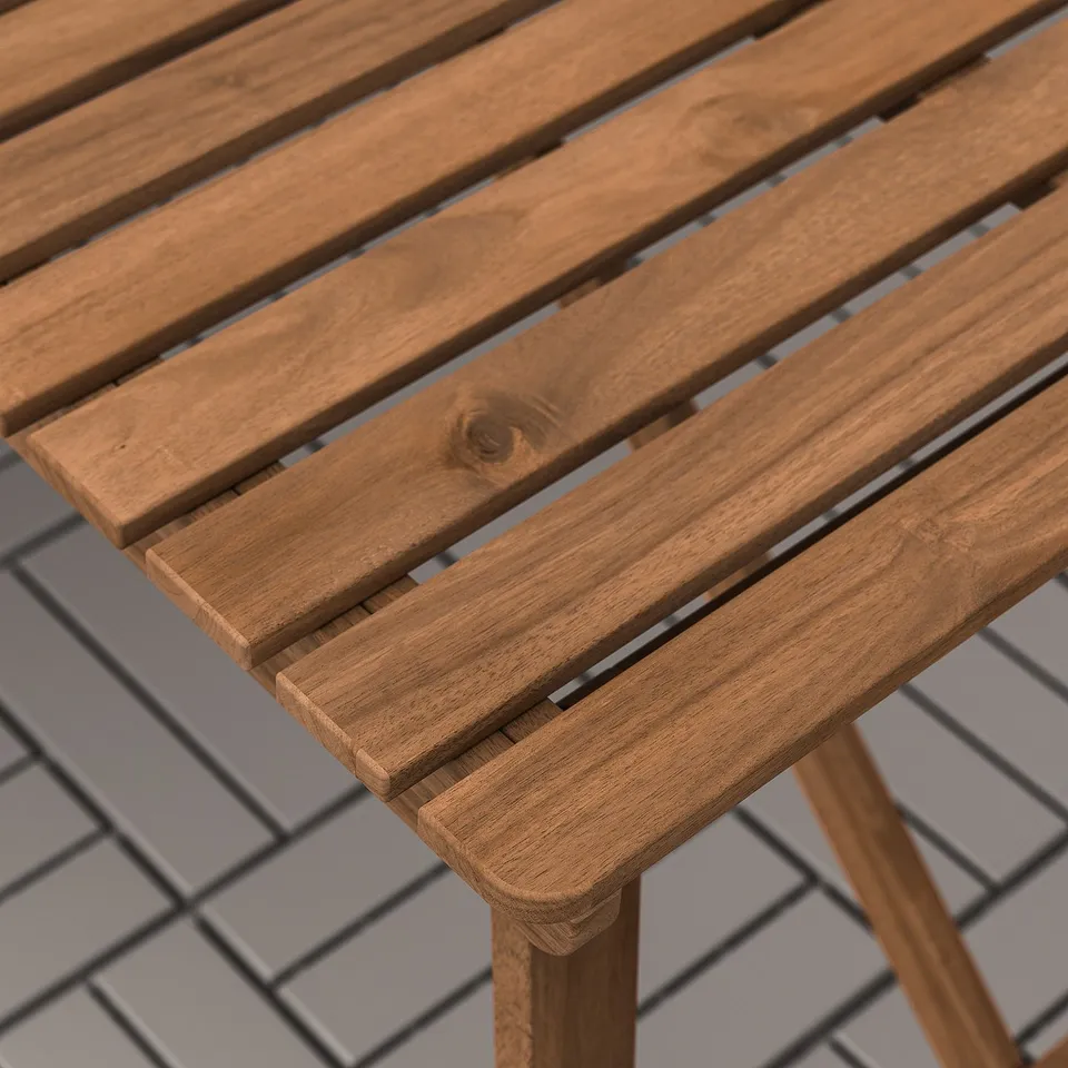Acacia wooden outdoor table with slatted design on tiled floor, ideal for garden or patio.