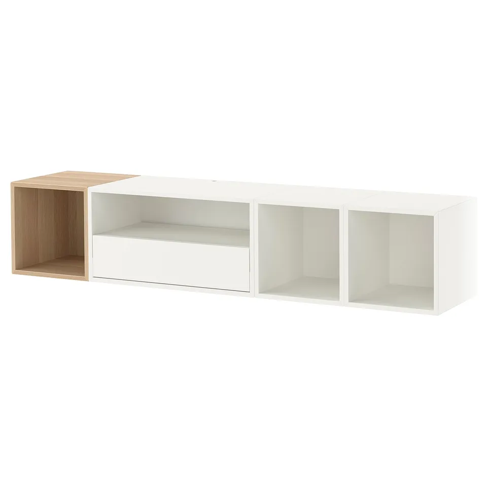 An ikea EKET white and wood shelf. It has multiple open compartments.