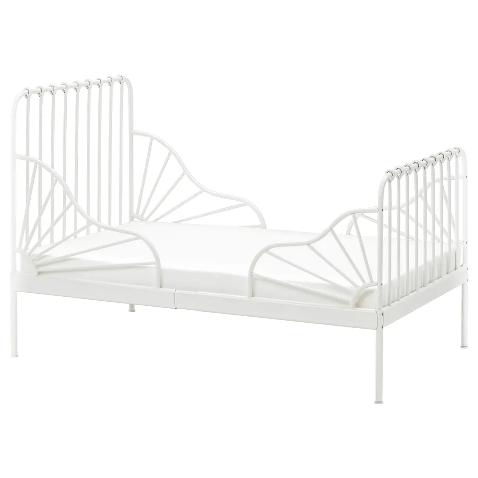 A white MINNEN extendable metal bed for children, featuring a classic design with vertical bars and circular accents at the head and foot.