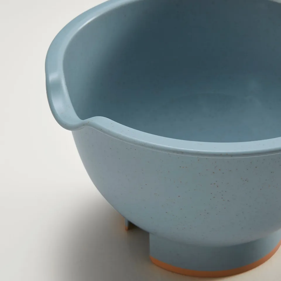 Light blue mixing bowl with handle, spout for easy pouring, anti-slip base.