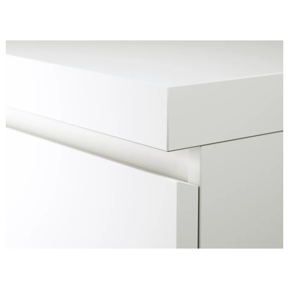 Clean, minimalist desk with sleek white surface, smooth edges, and hidden cable management.