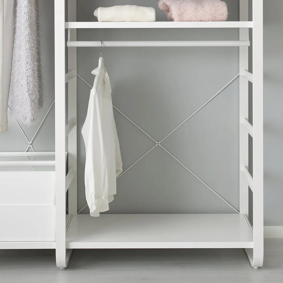 White metal storage shelf with clothes hanger.