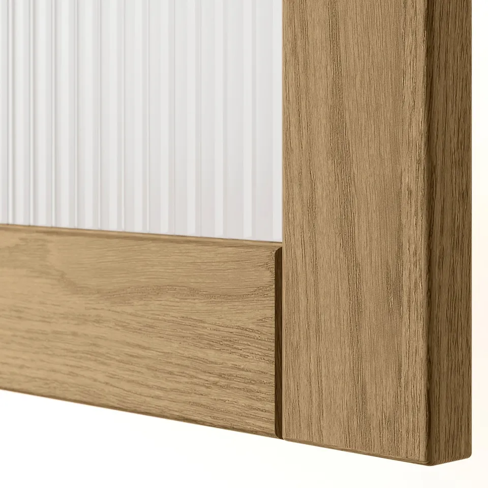 Close-up of a wooden framed door corner, showcasing smooth, high-quality oak veneer finish and clean craftsmanship.