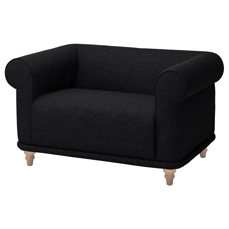 Comfortable black VISKAFORS armchair with soft, rounded shapes, wooden legs, and a cosy, embracing design.