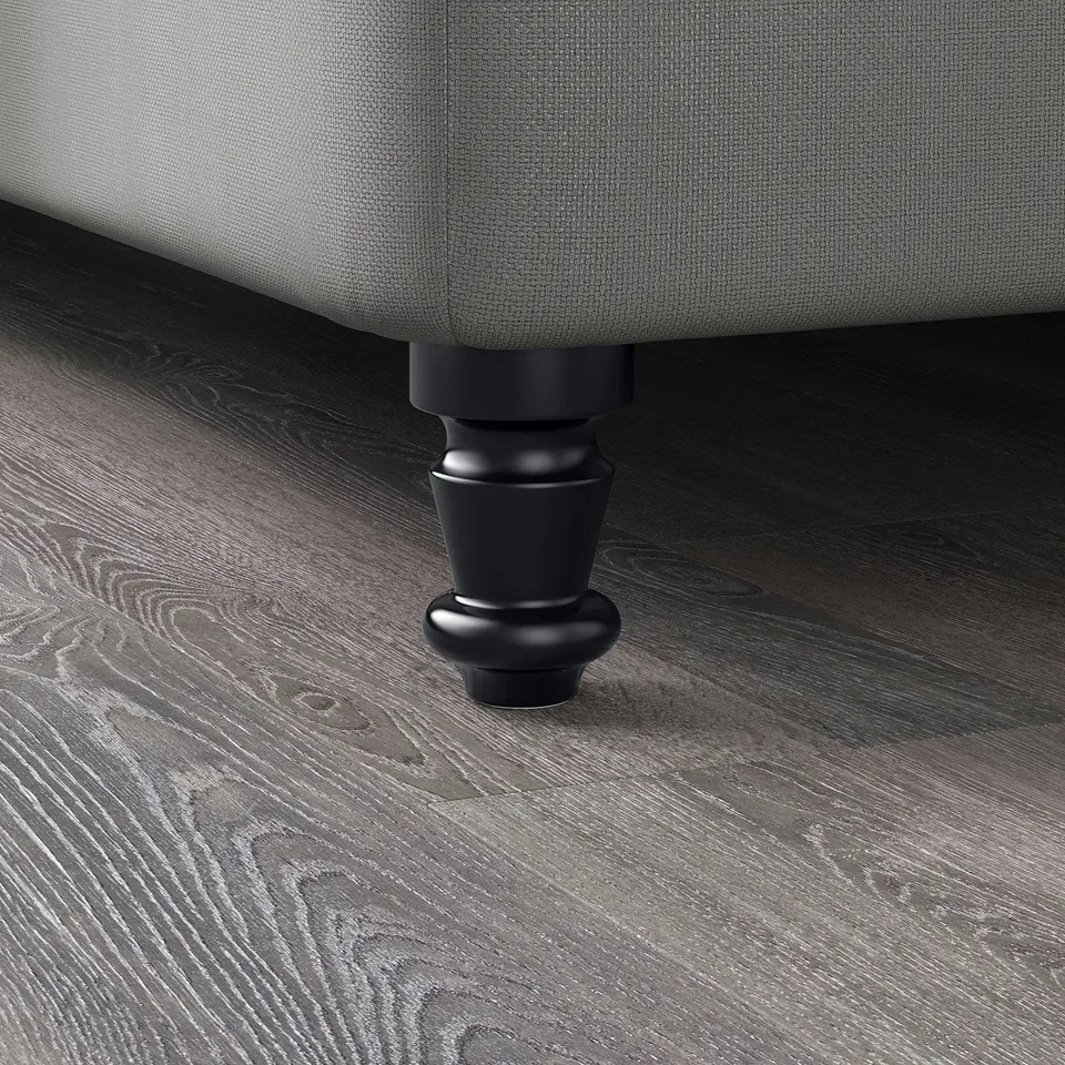 Dark grey upholstered furniture with solid black wooden legs on a textured wooden floor.