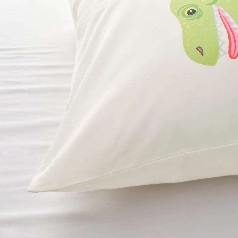 White pillowcase featuring a cute green dinosaur print, showcasing soft, high-quality fabric.